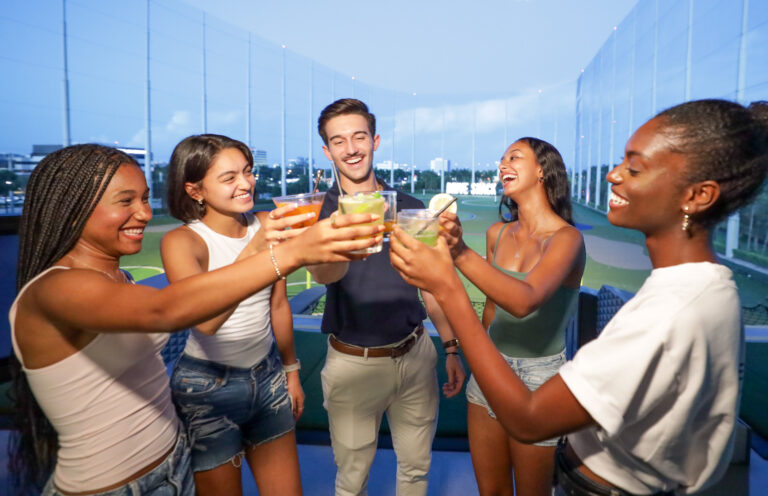 Group of adults cheering with drinks