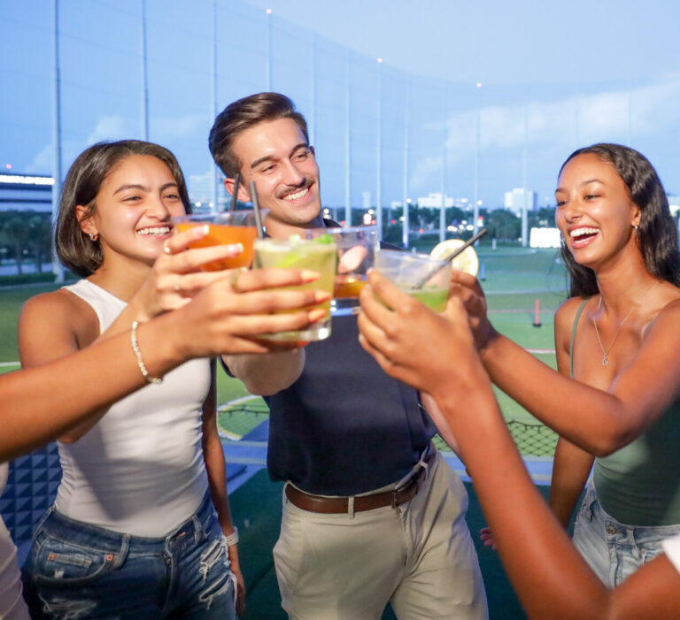 Three guests cheering with drinks