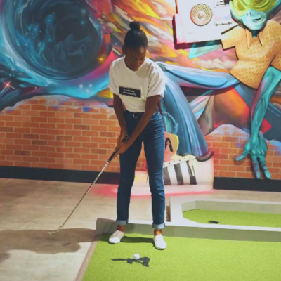 Alien-themed murals and interstellar scenery create a captivating backdrop at Drive Shack's mini golf course, designed by Puttery.